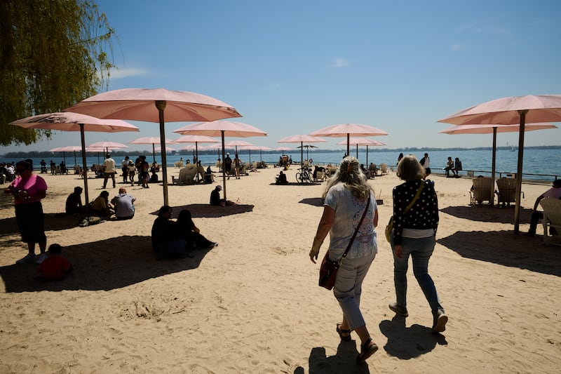 People visit the waterfront at Sugar Beach park in Toronto on May 17, 2026. (Sammy Kogan / The Canadian Press)