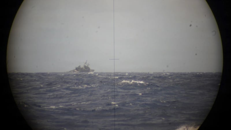 The decommissioned guided-missile cruiser USS Mobile Bay, viewed through the periscope of Royal Canadian Navy Victoria-class long-range patrol submarine HMCS Corner Brook on July 12, 2026. (Royal Canadian Navy)