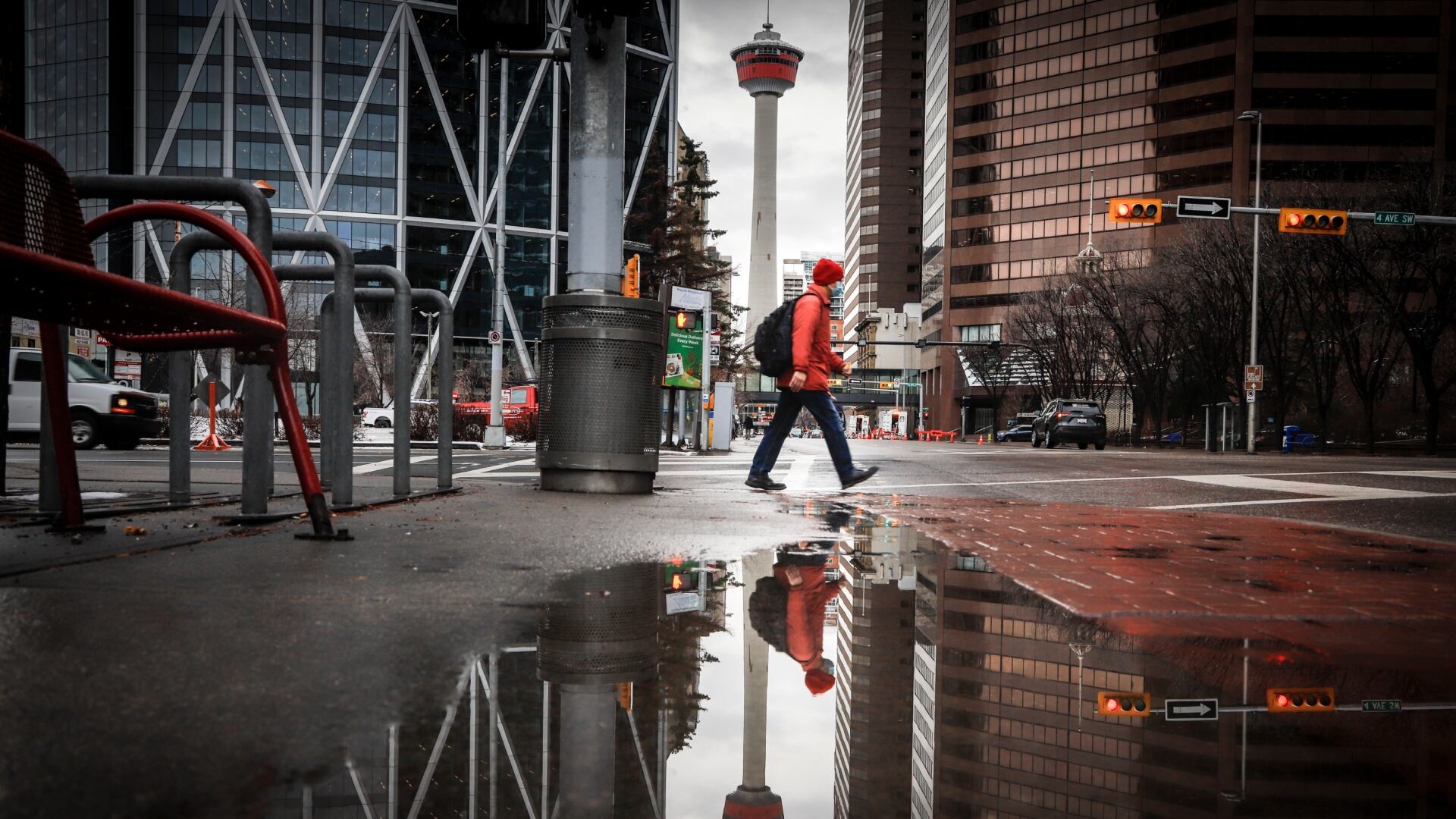 A pedestrian wearing a mask walks through an empty downtown Calgary, Alta., Wednesday, Dec. 9, 2020, after new provincial restrictions were announced amid a worldwide COVID-19 pandemic. THE CANADIAN PRESS/Jeff McIntosh