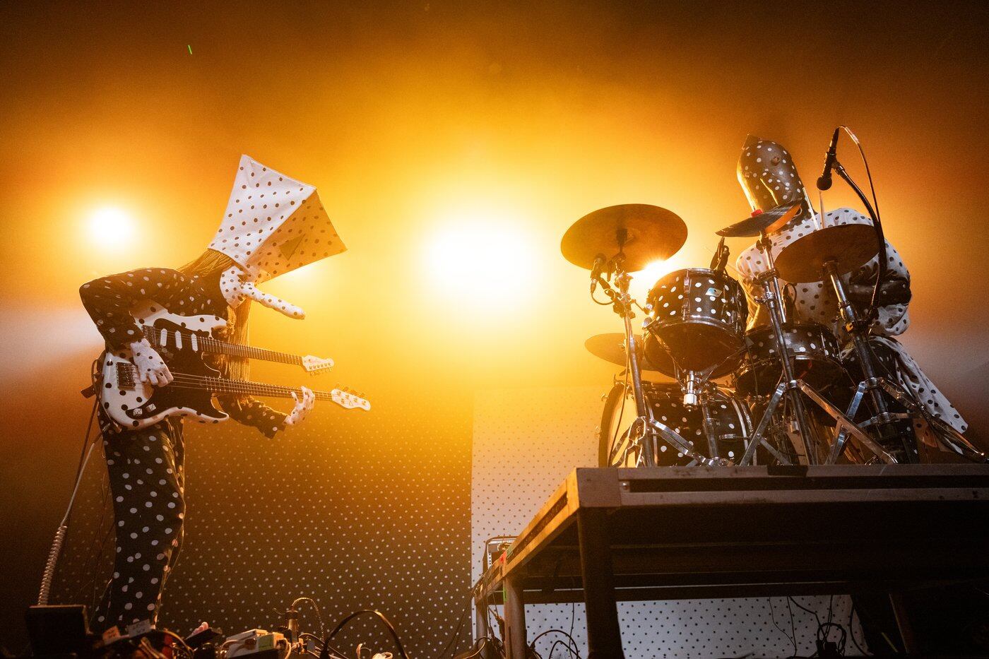 Angine de Poitrine performing in their masked polka-dot costumes