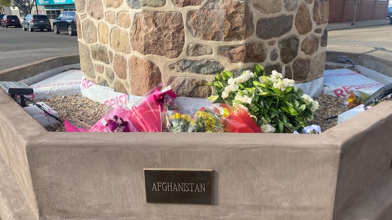 Flowers are seen at the Memorial Clock Tower on Main Street in Wainwright, Alta., on Oct. 19, 2026, two days after the deadly incident at the local Canadian Armed Forces base. (Darcy Seaton / CTV News Edmonton)