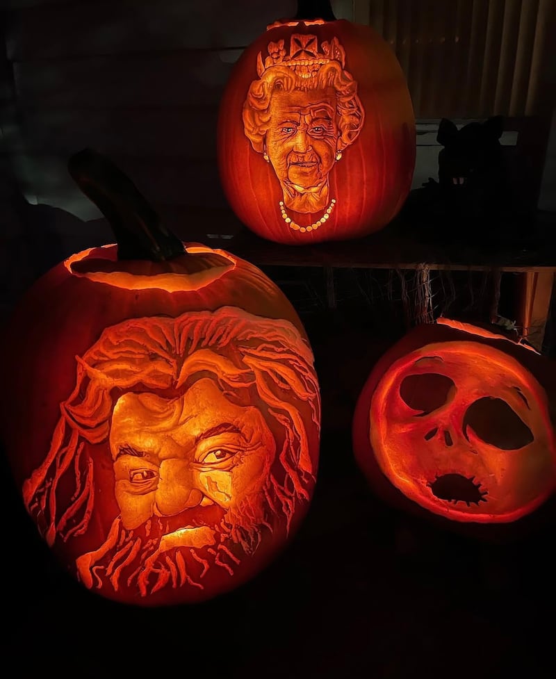 The Queen is pictured among Bustin's carvings. (Courtesy of Matt Bustin)