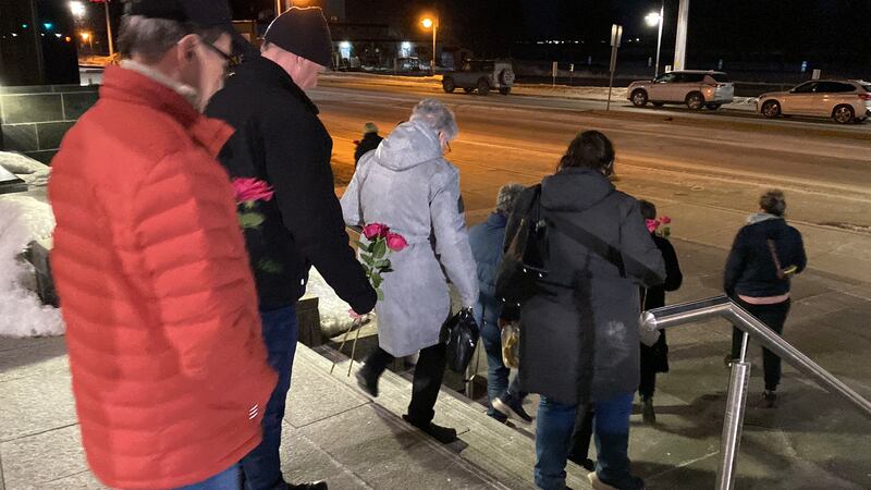 Bernard and Rose-Marie Saulnier's family are pictured carrying roses out of the Moncton courthouse. (Derek Haggett/CTV Atlantic)