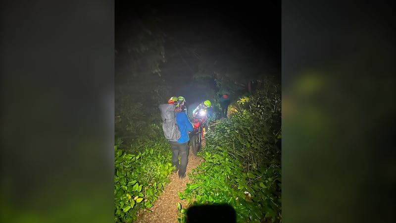 Rescuers transport a patient toward the Pachena Bay Information Centre.