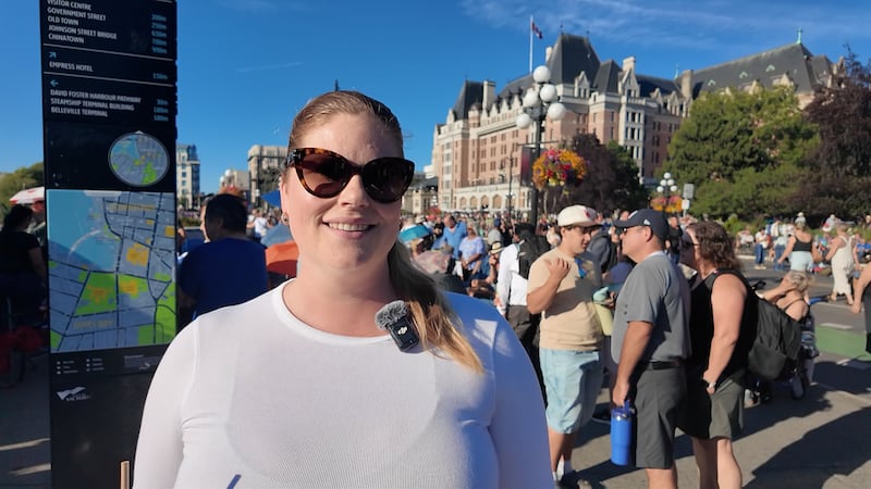 Chelsea Skaalrud looks for the best spot to watch David Foster’s free 40th anniversary concert as she waits for the show to begin in Victoria’s Inner Harbour on Aug. 8, 2026.