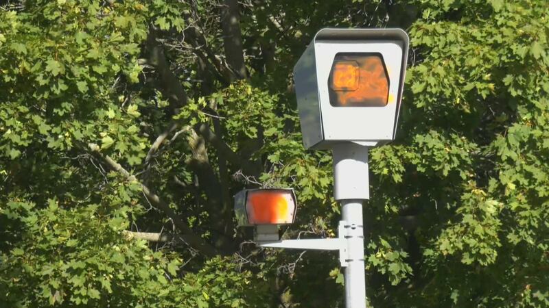 A photo radar camera that has had it's lens vandalized by orange spray paint.