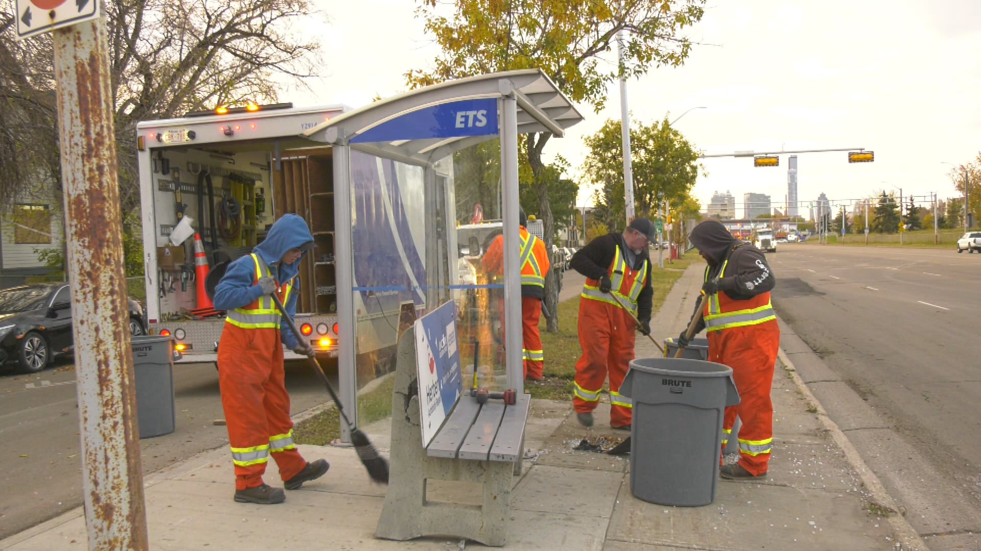 Workers clean up broken glass at a bus stop at 97 Street and 120 Avenue after a fatal crash on Oct. 13, 2026. (Darcy Seaton/CTV News Edmonton)