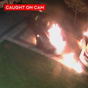 Arson suspect shown dousing vehicles in gasoline and igniting them