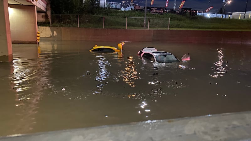 Two vehicles are seen nearly submerged near the 127 Street and 127 Avenue Yellowhead Trail underpass in Edmonton the morning of July 15, 2026. (Nicole Lampa / CTV News Edmonton)