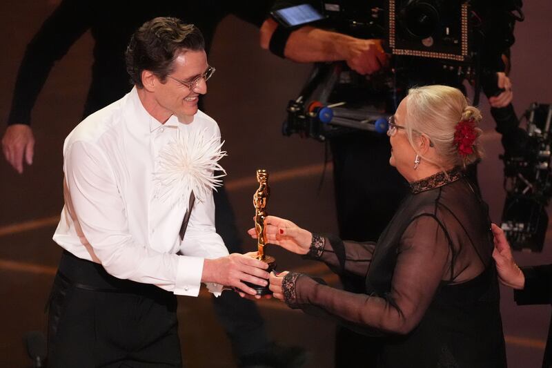 Pedro Pascal, left, presents the award for best production design to Tamara Deverell for "Frankenstein" during the Oscars on Sunday, March 15, 2026, at the Dolby Theatre in Los Angeles. (AP Photo/Chris Pizzello)