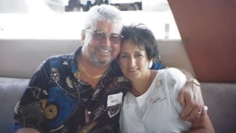 A man and woman pose together for a photo.
