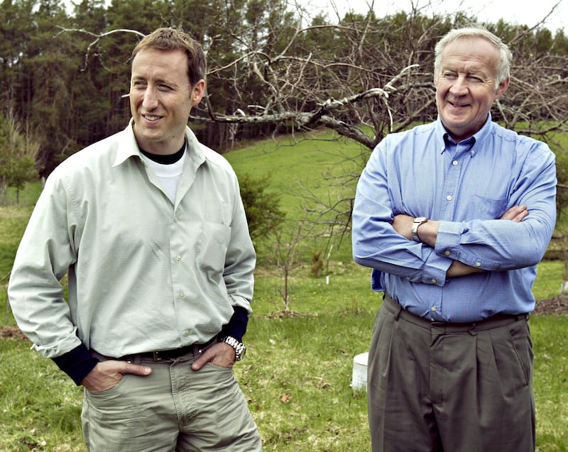 Peter MacKay, left, former deputy Conservative leader, and his father Elmer, a former federal Conservative cabinet minister, take a break from chores at home in Lorne, N.S., on Wednesday May 18, 2005. (CP PHOTO/Andrew Vaughan)
