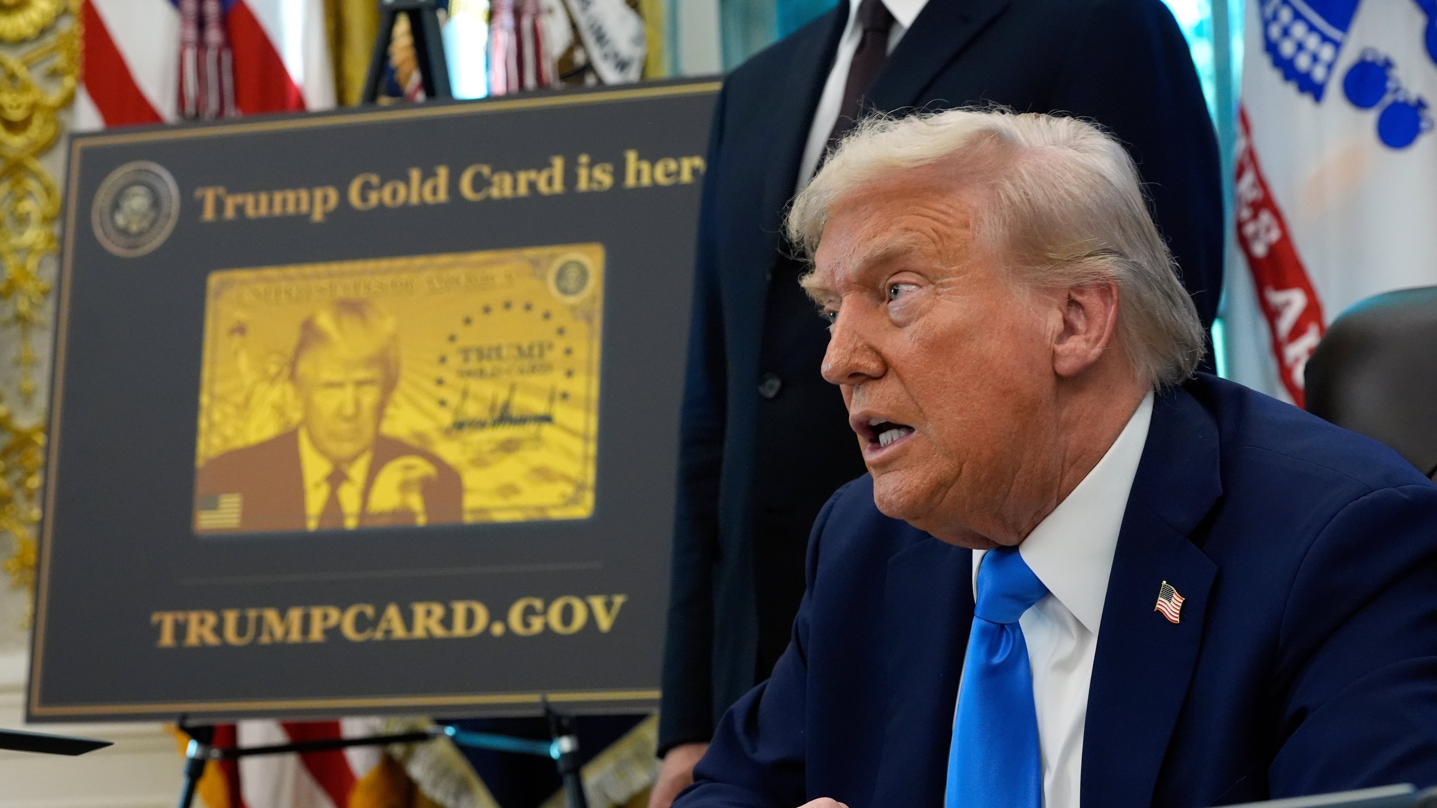 A poster showing the Trump Gold Card is seen as U.S. President Donald Trump signs executive orders in the Oval Office of the White House on Sept. 19, 2025. (Alex Brandon / AP Photo)
