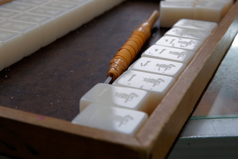 Mahjong game tiles with Chinese characters engraved by Cheung Shun-king sit in their case at a shop in Kowloon's old neighbourhood of Hong Kong on April 18, 2019. (Kin Cheung / AP Photo)
