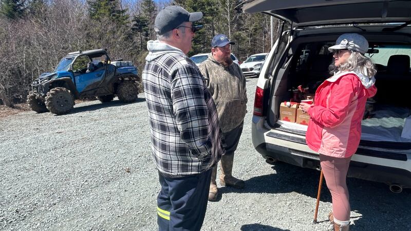Three members of the team searching for Lilly and Jack Sullivan are pictured with vehicles near Lansdowne Station, N.S., on April 26, 2026. (Jonathan MacInnis, CTV Atlantic)