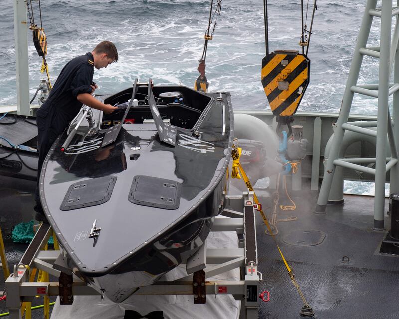 A sailor performs maintenance on a Hammerhead vessel aboard HMCS Margaret Brooke off the coast of Cape Breton, NS, on Aug 3, 2022. (Cpl. Kuzma/Canadian Armed Forces)