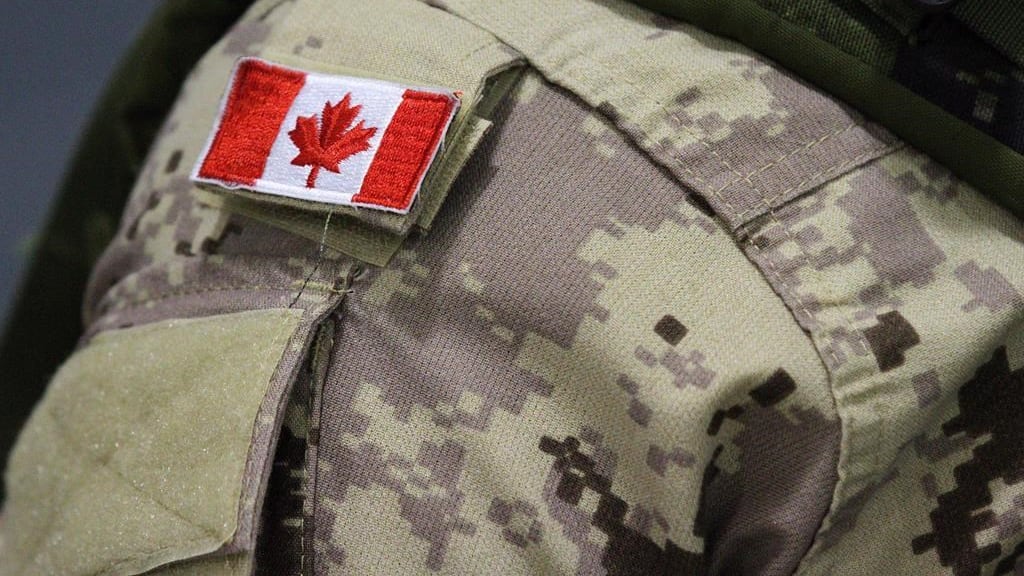 A Canadian flag patch is shown on an Armed Forces member's uniform in Trenton, Ont., on October 16, 2014. (THE CANADIAN PRESS/Lars Hagberg)