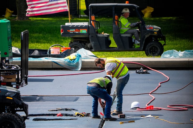 Workers apply paint to the Reflecting Pool on May 14. (Andrew Harnik/Getty Images via CNN Newsource)