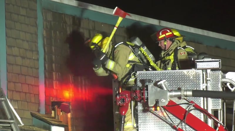 Firefighters battle a blaze that heavily damaged a bike shop in downtown Cumberland.