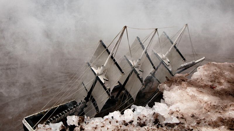 A miniature boat in the fog.