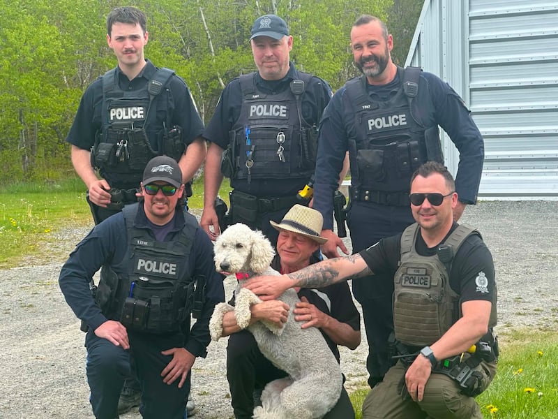 Robert Stubbert poses with his dog Charlie and several Cape Breton police officers. (Courtesy: Fran Murphy)