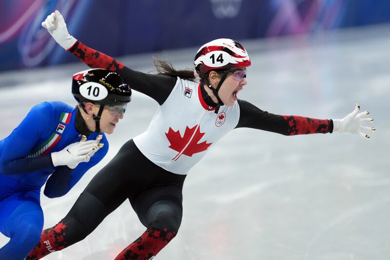 Canada's Courtney Sarault celebrates a bronze finish as Italy's Arianna Fontana gets the silver during the women's 500 metre short track speedskating finals at the 2026 Winter Olympics, in Milan, on Thursday, February 12, 2026. (THE CANADIAN PRESS/Darryl Dyck)