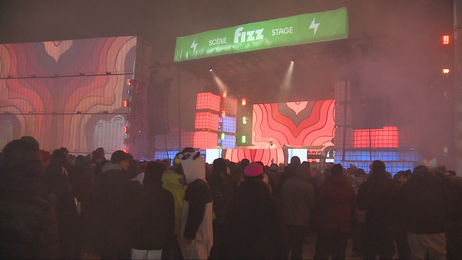 A crowd of people dance while lights shine at Igloofest in Gatineau, Que.