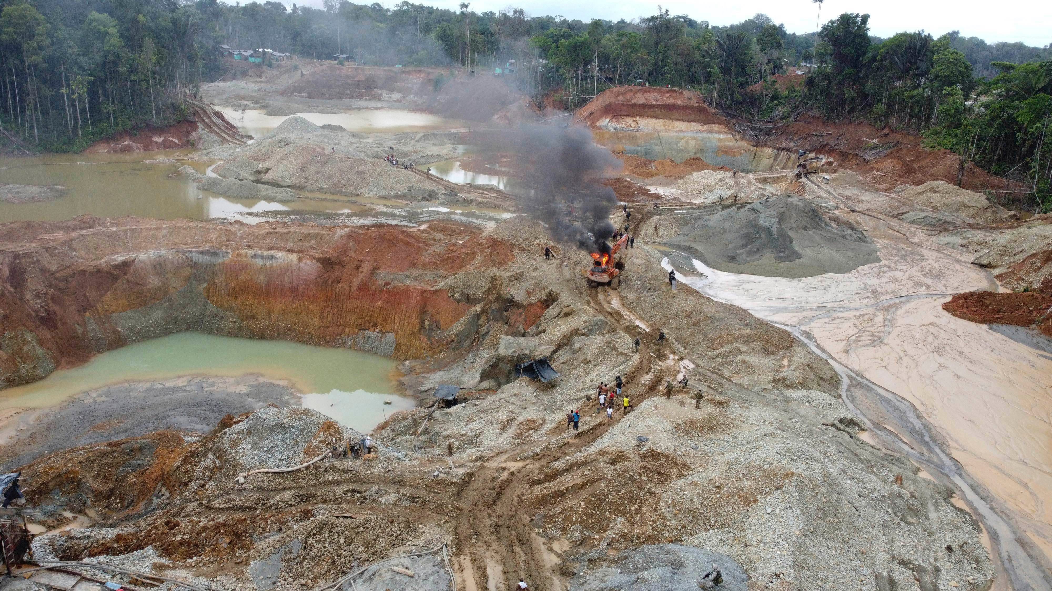 The National Police destroy an illegal gold mining operation with soldiers standing guard as part of the Armed Forces' 'Operation Guamuez III' in Magui Payan, Colombia on April 20, 2021. (Fernando Vergara / AP Photo)