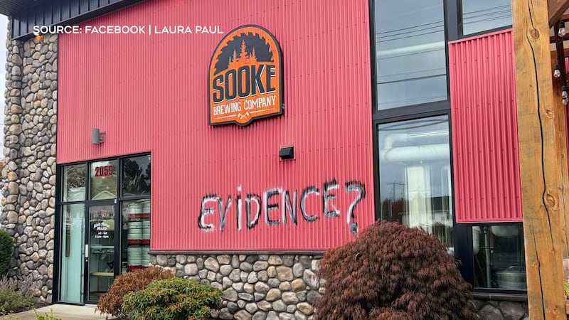 “Evidence?” is spray painted on the side of Sooke Brewing Company following backlash over a co owner’s “Show Me the Evidence” shirt.