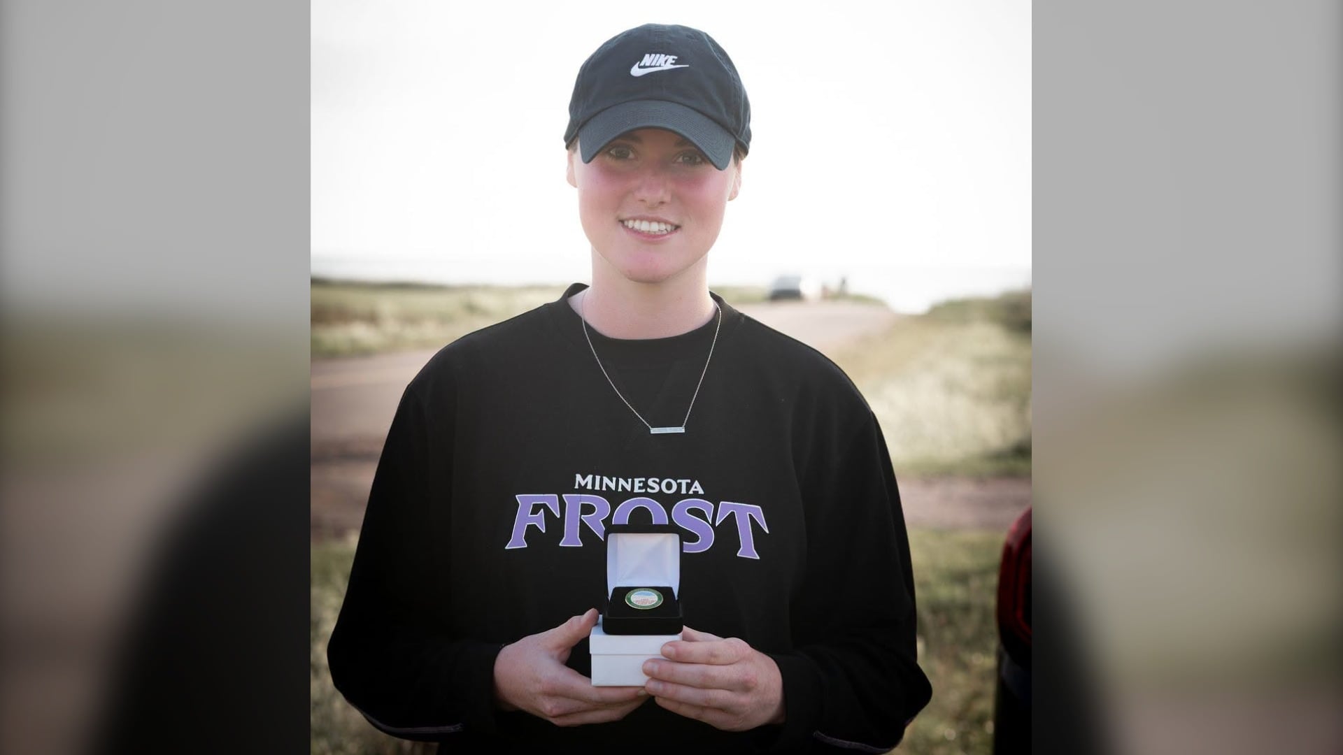 Abby Hustler is pictured holding an Excellence in Sport pin in Miminegash, P.E.I. (Source: Facebook/Prince Edward Island Government)