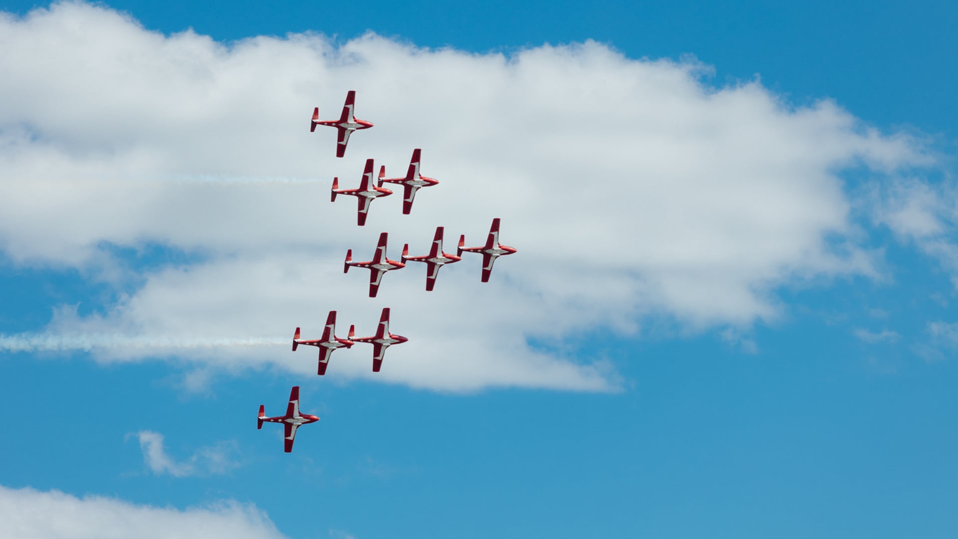 Nine planes fly overhead.