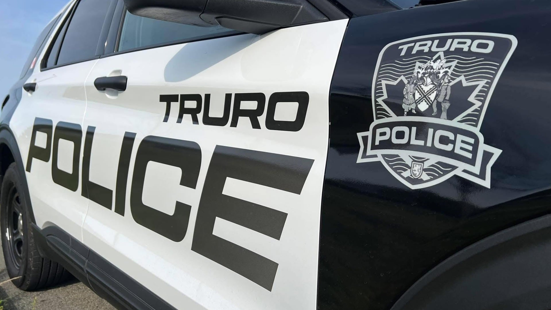 A black and white police vehicle is pictured with the words "Truro Police" on the side.