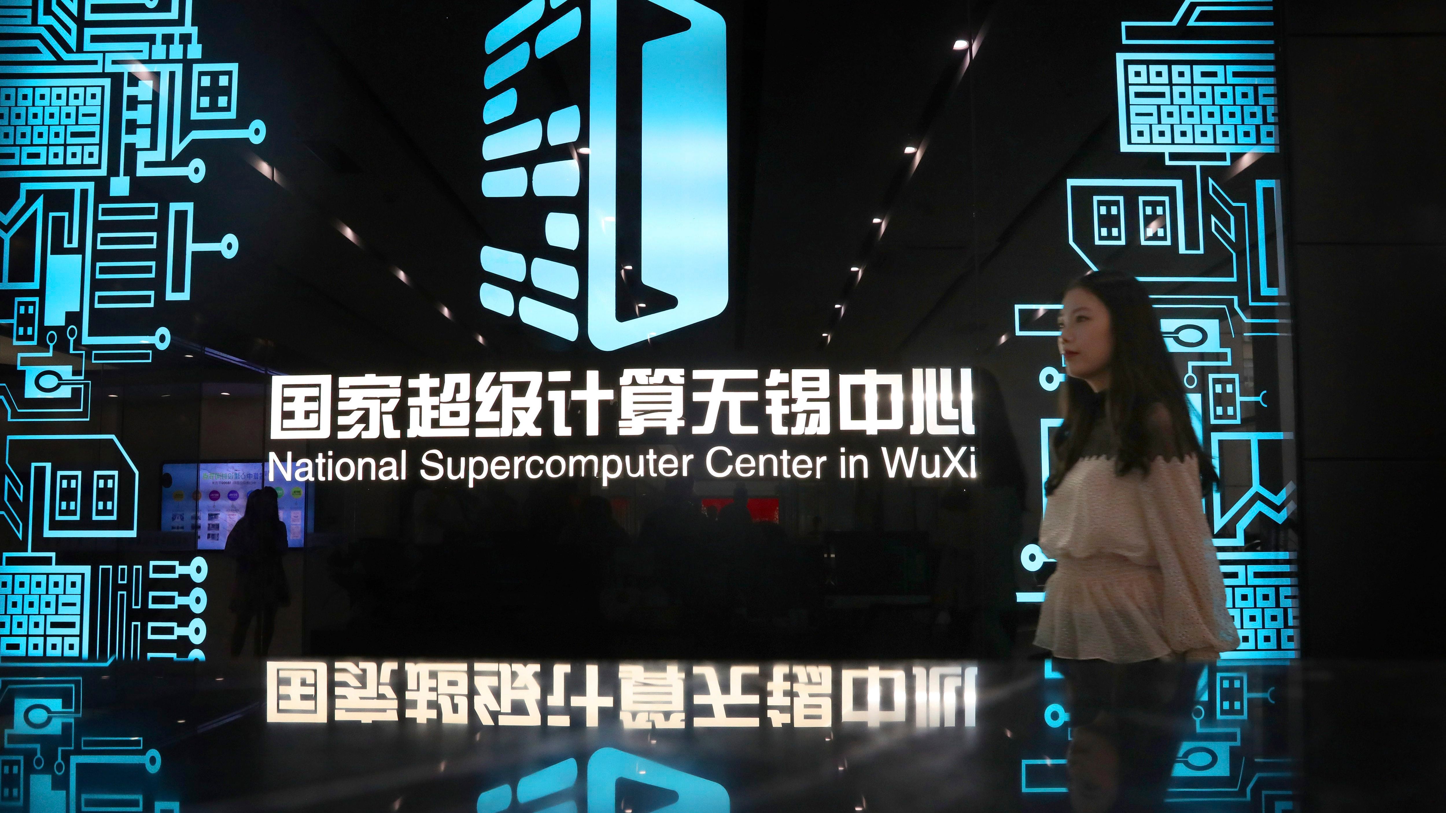 A woman walks in the hallway of the National Supercomputer Center, which hosts the Shenwei (Sunway) TaihuLight supercomputer, in Wuxi in eastern China's Jiangsu province on Aug. 29, 2020. (Chinatopix via AP)