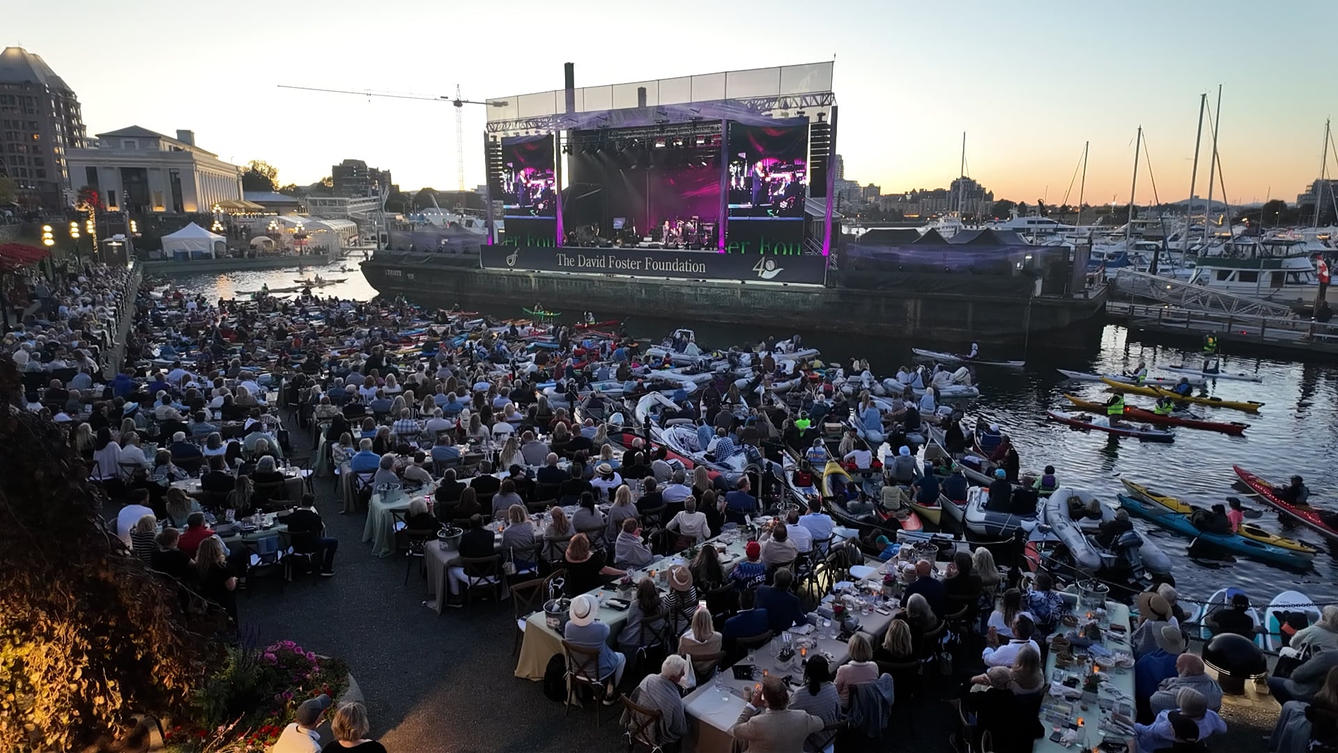 David Foster performs on a floating stage as concertgoers watch from the water and the Victoria waterfront during his free 40th anniversary concert in Victoria’s Inner Harbour on Aug. 8, 2026.