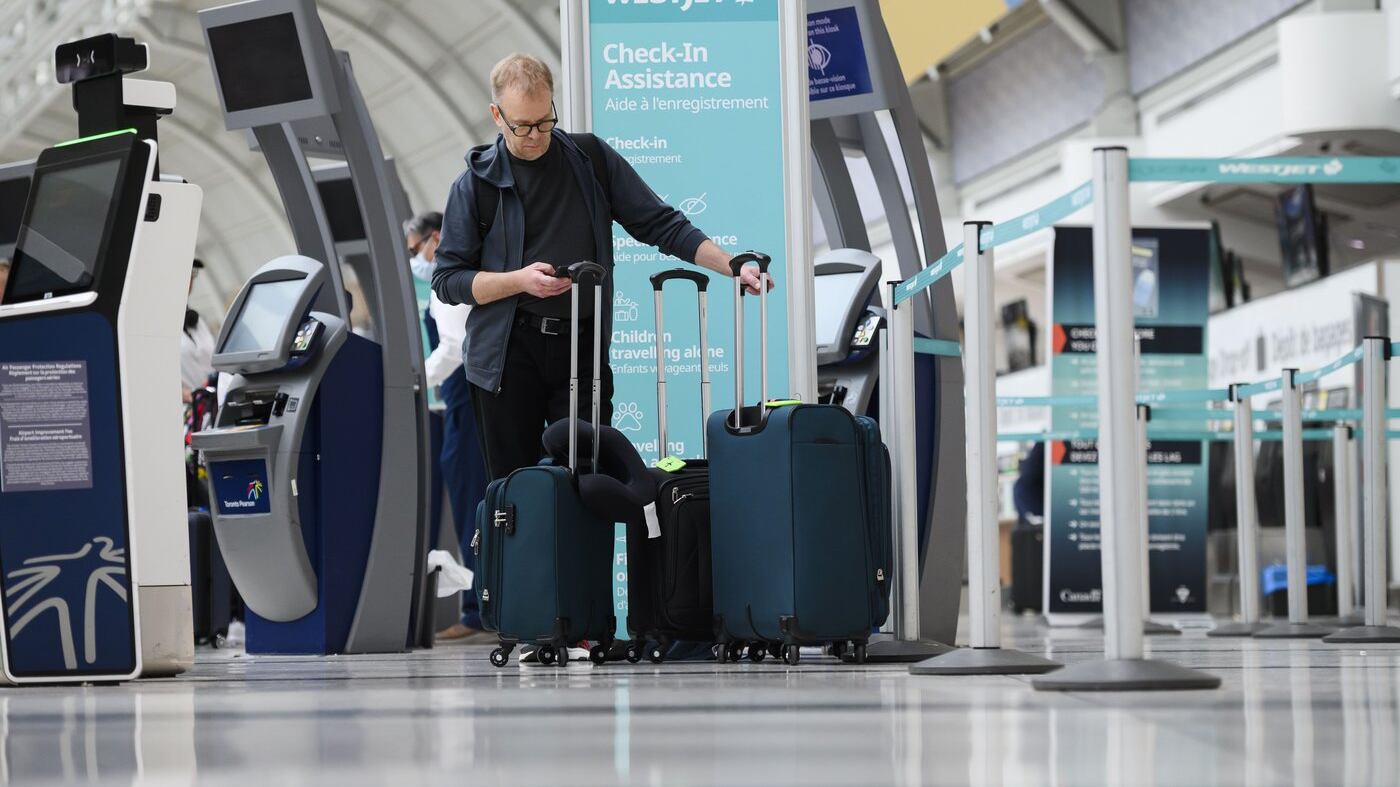 Passengers are seen in the WestJet check-in area at Pearson International Airport, in Toronto, Saturday, June 29, 2024. (THE CANADIAN PRESS/Christopher Katsarov)