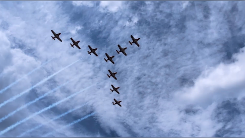 Nine planes fly overhead.
