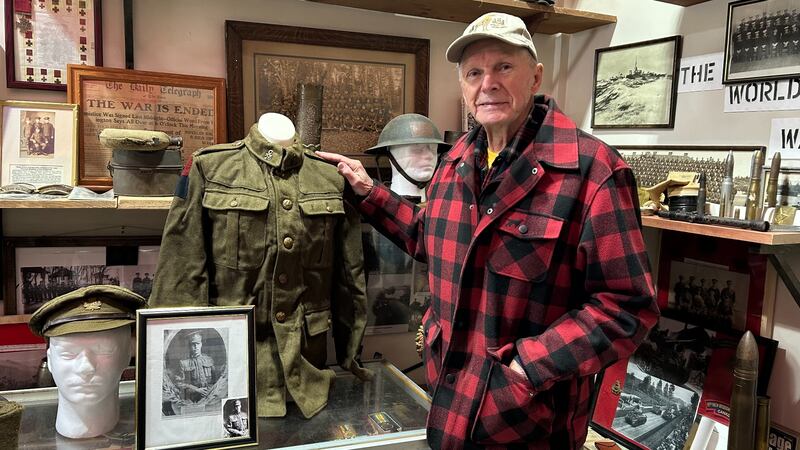 Roger Way is pictured with his father's First World War uniform, which he donated to the Carleton County Military Museum. (Avery MacRae / CTV Atlantic)