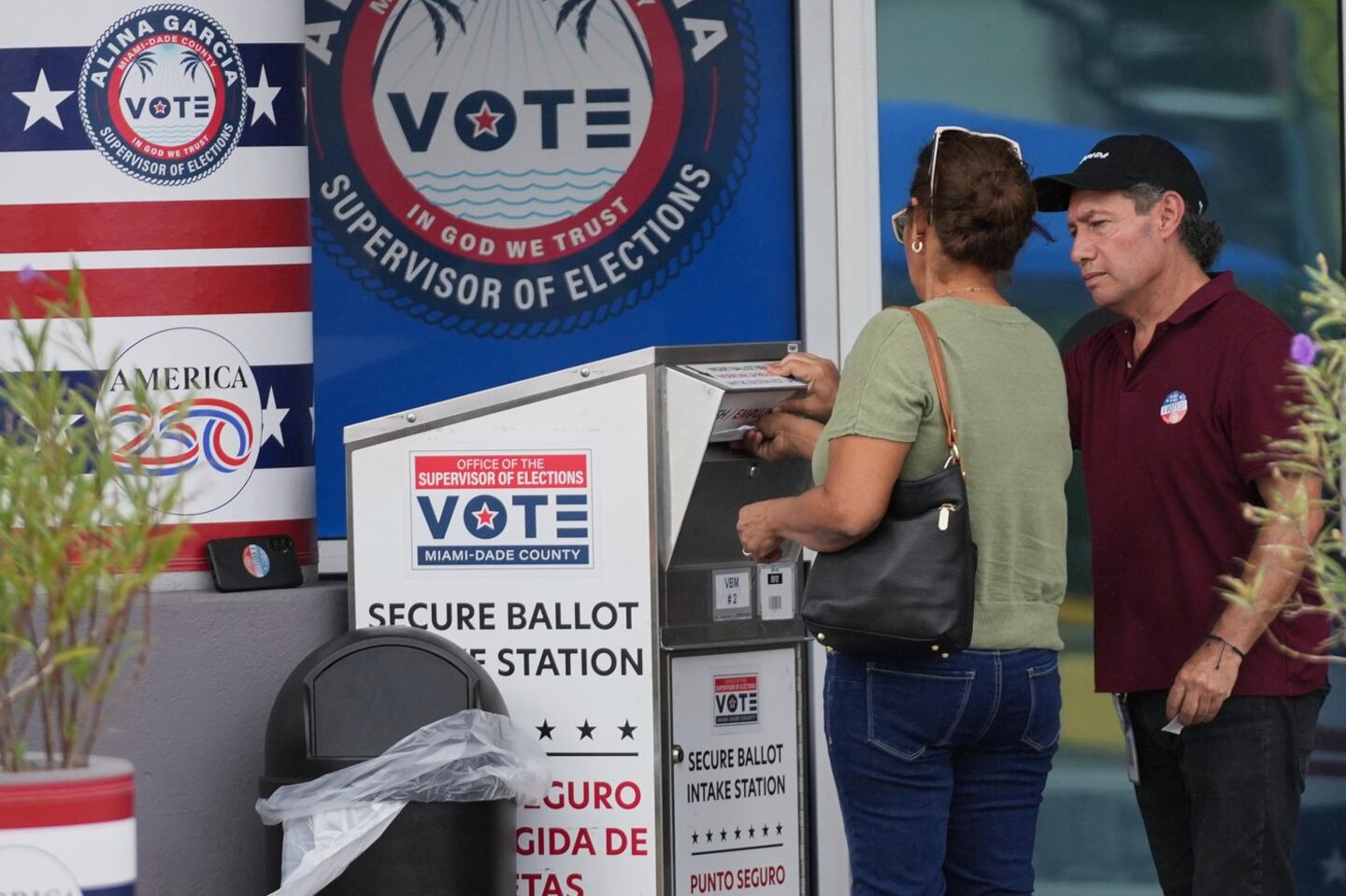A person drops a vote-by-mail ballot in a secure ballot intake station at the Office of the Supervisor of Elections during early voting in the 2026 midterm elections, Tuesday, Oct. 27, 2026, in Doral, Fla