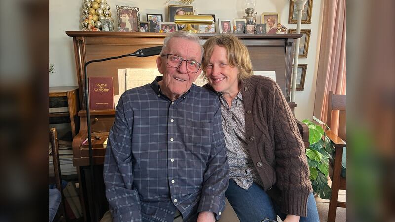 Cedric Landers sits in front of his piano with his daughter Loralee Druart at his home in Lutes Mountain, N.B., on Jan. 31, 2026. (Derek Haggett / CTV Atlantic)