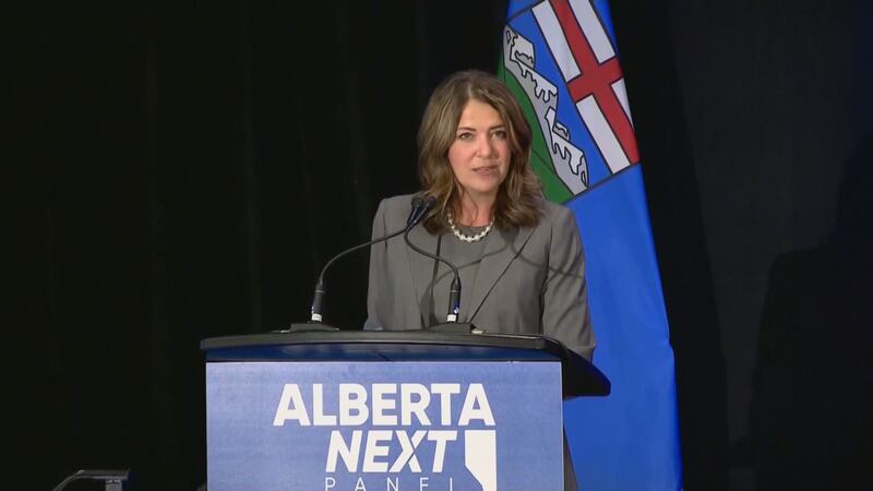 Alberta Premier Danielle Smith speaks at a podium during an Alberta Next panel in Edmonton on Aug. 14, 2025.