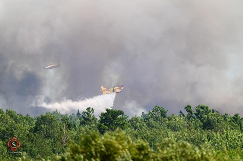 Air support is pictured at the scene of a forest fire in Irishtown, N.B., on Aug. 10, 2025. (Source: Facebook/Codiac Response)