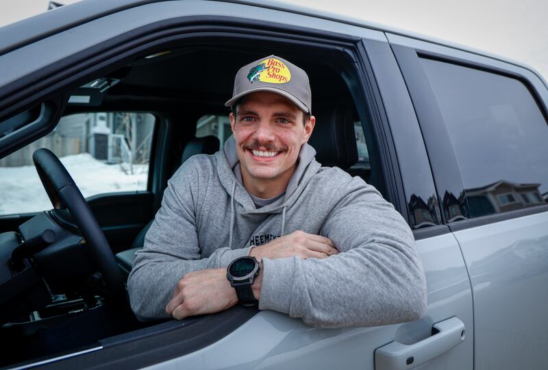 Colten Petty who helped rescue pets poses in his truck 10 years after a wildfire in Fort McMurray, Wednesday, April 15, 2026.THE CANADIAN PRESS/Jeff McIntosh